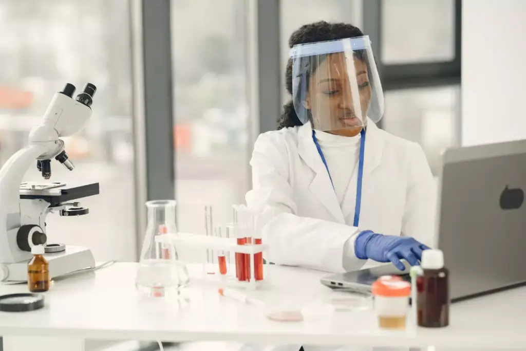 A clinical laboratory with modern medical equipment, including an IV stand, syringes, and medication vials. In the foreground, a woman sits in a chair, her expression reflecting the gravity of the situation. Surrounding her, doctors and nurses in white coats move with a sense of purpose, working to administer the appropriate chemotherapy treatments. The lighting is bright and clean, casting a hopeful glow on the scene. The angle is slightly elevated, allowing the viewer to observe the intricate details of the medical procedures and the patient's experience. The overall atmosphere conveys the critical role of chemotherapy in breast cancer treatment, with a sense of care, professionalism, and determination to provide the best possible outcome.