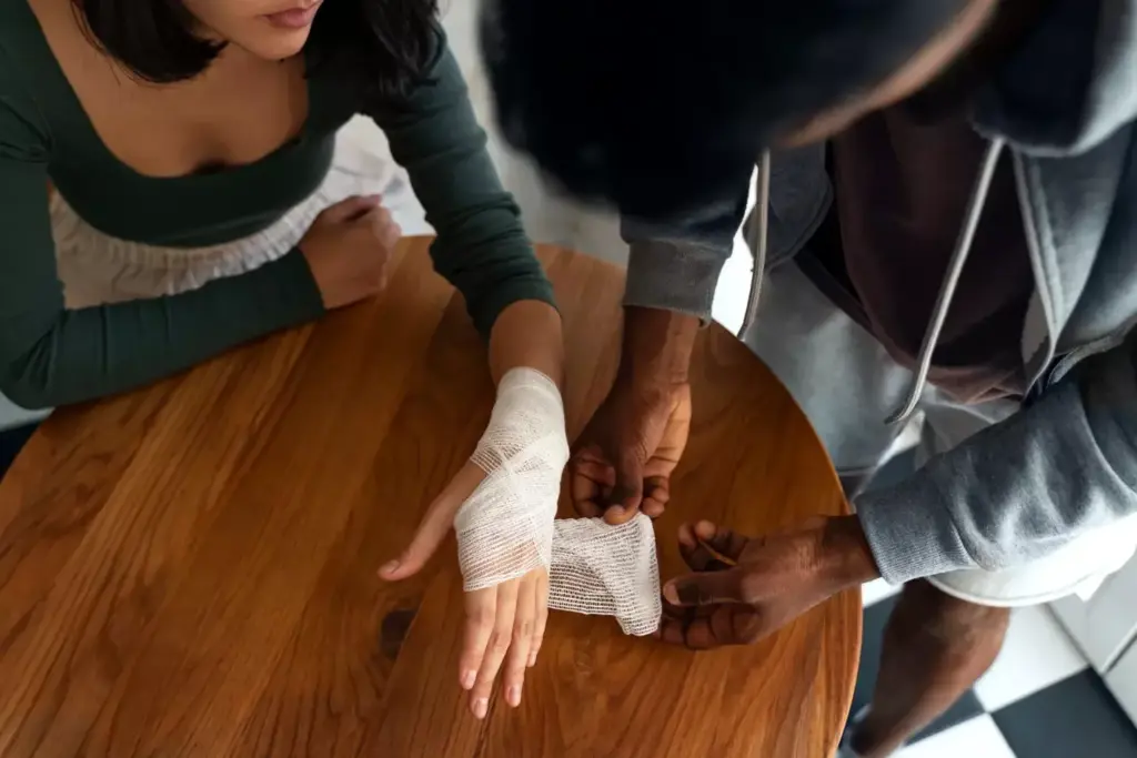 A close-up view of a human hand with a visible surgical scar on the palm, showcasing proper wound care techniques. The hand is gently bandaged, with a clear, sterile dressing covering the incision. Soft, diffused lighting illuminates the scene, creating a calming, clinical atmosphere. The background is blurred, keeping the focus on the hand and the healing process. The image conveys the importance of meticulous scar management in the initial stages of recovery from carpal tunnel release surgery.