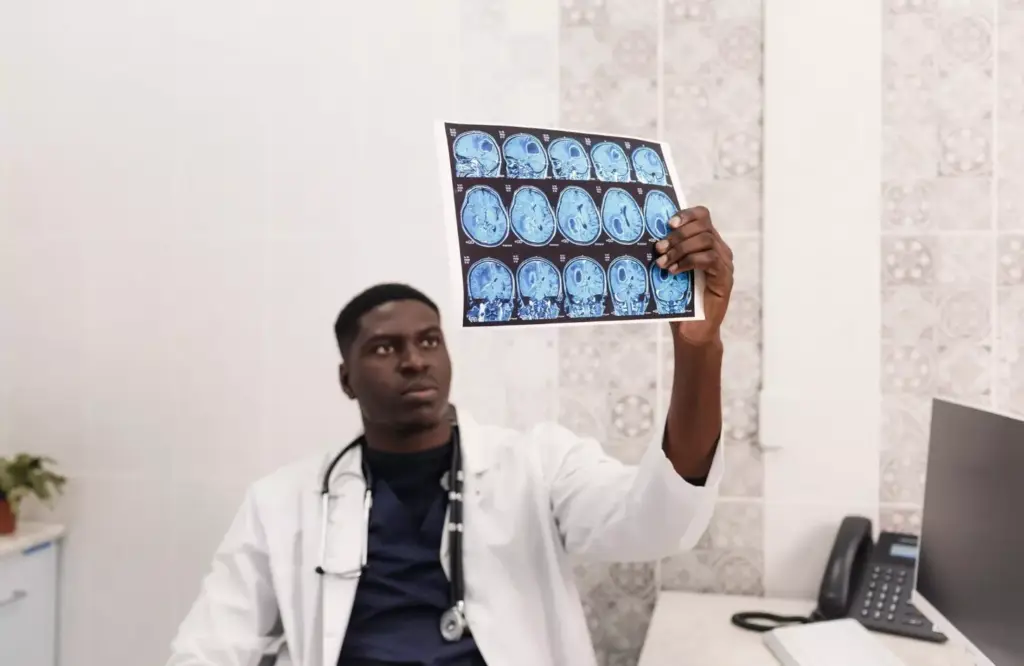 A detailed anatomical illustration of the human brain, showcasing the key risk factors associated with brain tumors. In the foreground, a cross-sectional view of the brain, with highlighted areas indicating factors such as genetic predisposition, exposure to ionizing radiation, and environmental carcinogens. The middle ground depicts a series of icons and symbols representing lifestyle factors like obesity, poor diet, and lack of physical activity. In the background, a subtle backdrop of neural pathways and cerebral vasculature, conveying the complexity of the organ. Rendered in a muted color palette with a sense of scientific precision, the overall composition emphasizes the importance of understanding and mitigating these risk factors for brain tumor prevention.