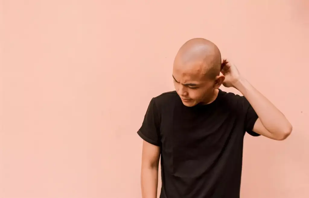 A detailed close-up of a cancerous basal cell lesion on human skin. The foreground shows the irregular, raised, pearly-white or pink growth with telangiectatic blood vessels visible on the surface. The middle ground reveals the distinct, raised edges and central indentation or ulceration. The background is a neutral, soft-focus scene to emphasize the lesion. Lighting is diffused and natural, creating subtle shadows that highlight the textural details. The image is captured with a high-resolution macro lens, allowing for exceptional clarity and detail of the atypical skin condition.