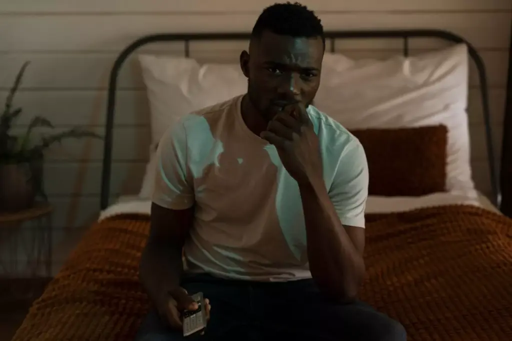 A dimly lit room with a pensive figure sitting on the edge of a bed, their face etched with worry and apprehension. The lighting casts ominous shadows, heightening the sense of unease. In the background, a looming silhouette of a brain tumor hovers, its ominous presence casting a foreboding shadow over the scene. The figure's posture is tense, their hands gripping the bedsheets as they grapple with the anxiety and uncertainty that comes with the possibility of a brain tumor. The overall atmosphere is one of tension, fear, and the weight of an invisible, yet palpable, threat.