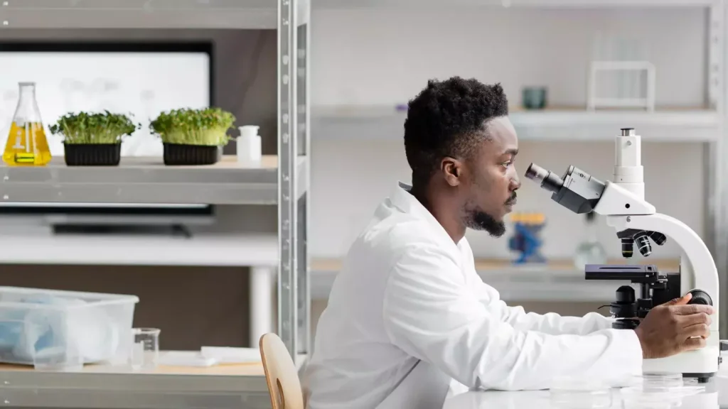A high-contrast, cinematic image of a CAR T cell clinical trial setting. In the foreground, a researcher in a white lab coat examines vials of cell samples under the bright glow of a microscope. In the middle ground, a team of scientists collaborates around a data-filled computer screen, their faces intently focused. In the background, sleek medical equipment and diagnostic machines lend an air of scientific authority to the scene. Moody lighting casts dramatic shadows, creating a sense of intensity and gravity around the important work being done. The overall atmosphere conveys the cutting-edge, high-stakes nature of these pioneering cancer immunotherapy trials.