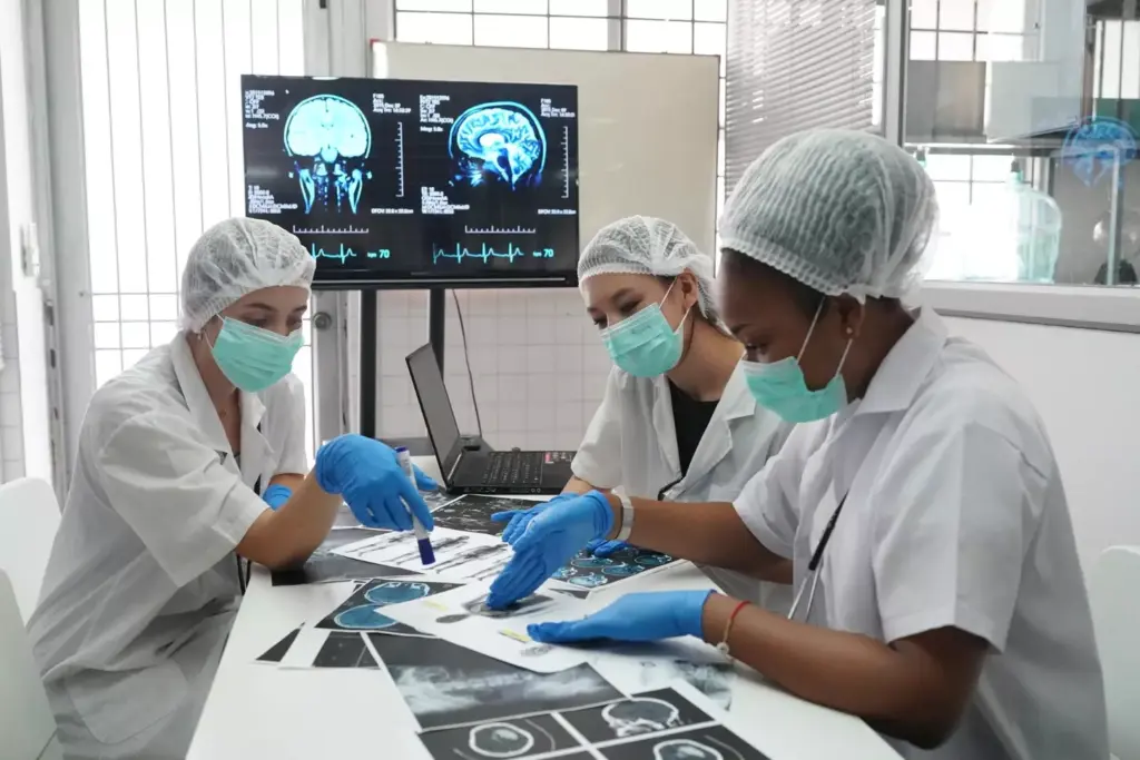 A highly detailed medical illustration depicting the brain biopsy procedure. The subject is positioned on an operating table, surrounded by a team of surgeons wearing sterile gowns and gloves. In the foreground, a surgeon is carefully inserting a thin needle into the patient's skull, guided by a high-resolution CT scan image displayed on a nearby monitor. The middle ground shows various surgical instruments and equipment, including a powerful microscope and a tray of specialized tools. The background is dimly lit, creating a somber, focused atmosphere in the operating room. The lighting is soft, directional, and casts long shadows, highlighting the delicate nature of the procedure. The scene conveys a sense of precision, expertise, and the gravity of the medical intervention.