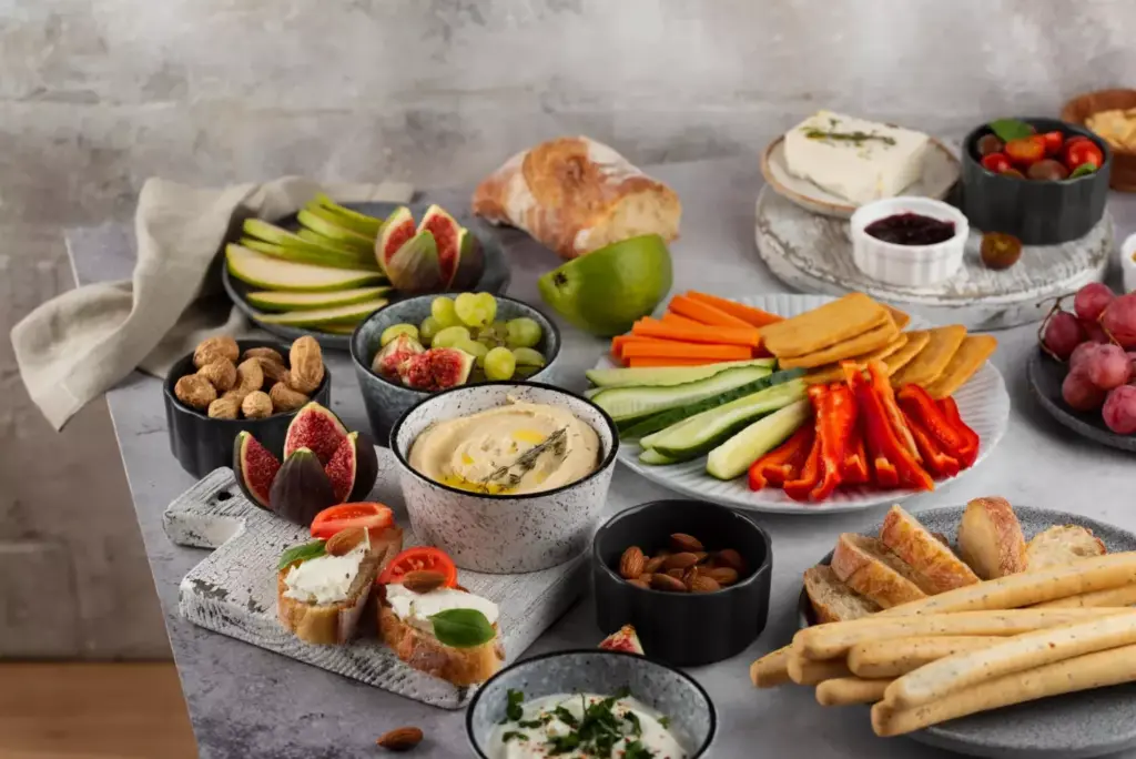 A nourishing spread of whole, nutrient-dense foods arranged on a wooden table, illuminated by warm, natural lighting. In the foreground, a plate showcases a variety of colorful fruits, vegetables, and lean protein sources, such as grilled chicken or fish, to represent a post-prostatectomy diet focused on promoting healing and recovery. The middle ground features a glass of water and a selection of nuts and seeds, highlighting the importance of hydration and nutrient-rich snacks. The background subtly suggests a serene, tranquil setting, emphasizing the calming and restorative atmosphere during this critical stage of post-surgery healing.