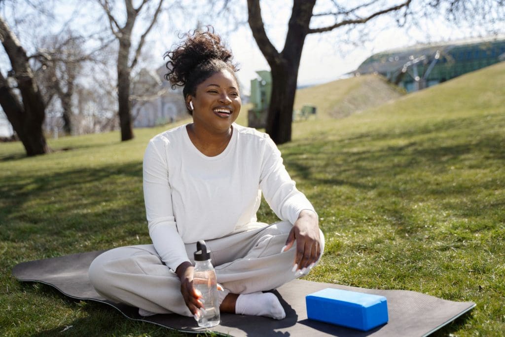 A peaceful garden setting with a central figure embodying a holistic approach to cancer care. In the foreground, a person sits in a serene meditative pose, radiating a sense of balance and inner harmony. Surrounding them, an array of medicinal herbs, flowers, and natural elements symbolize the integration of alternative therapies. In the middle ground, a warm, golden light filters through lush, verdant foliage, evoking a soothing, nurturing atmosphere. In the background, a distant horizon with a softly blurred, dreamlike quality suggests the expansive, interconnected nature of holistic healing. The overall composition conveys a calming, contemplative mood that encapsulates the essence of a holistic approach to cancer care.