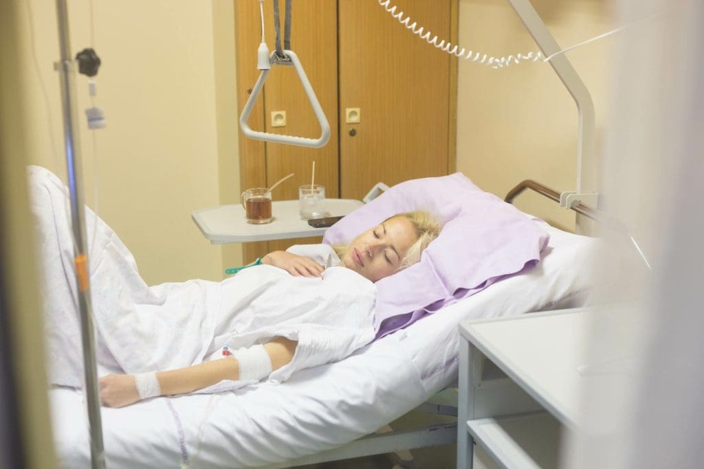 A serene hospital room with patient lying on bed