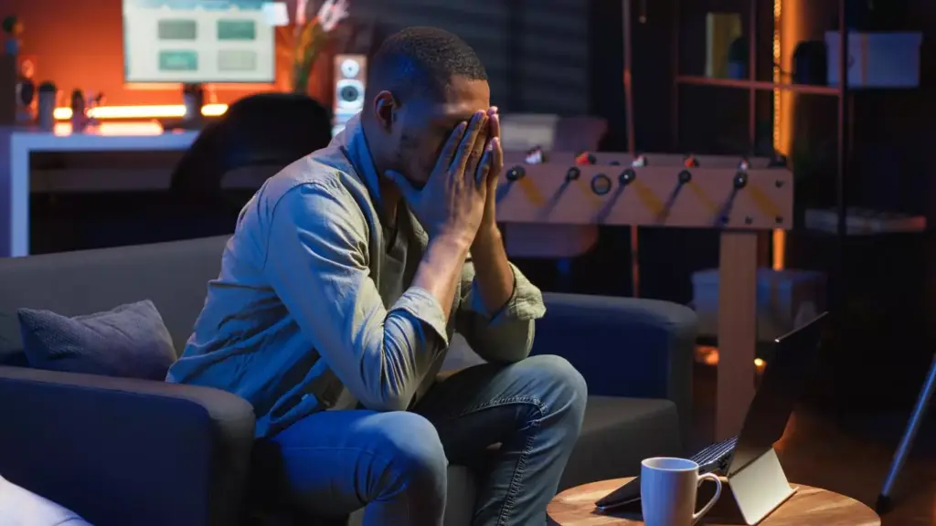 A thoughtful individual standing in a dimly lit room, gazing contemplatively at a medical chart depicting addiction-related data and statistics. The room's atmosphere is somber, with muted lighting creating shadows that convey a sense of introspection and the weight of the issue. In the background, subtly blurred, are shelves lined with books and medical supplies, hinting at the professional context. The figure's posture and expression suggest a deep understanding of the complexities of drug abuse and a commitment to finding solutions.