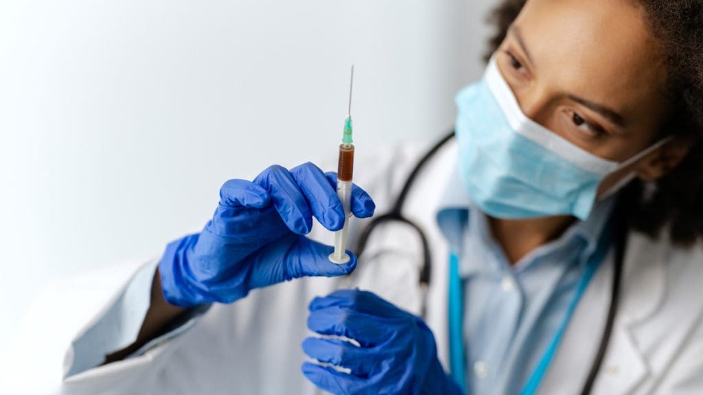 Doctor injecting hip