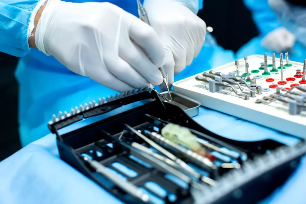 High-quality comparison of various bone grafting materials for dental implants, shot in a well-lit medical laboratory setting. In the foreground, different types of bone grafts, including xenografts, allografts, and synthetic bone substitutes, are arranged neatly on a clean white surface. The middle ground shows surgical instruments and tools used in the bone grafting procedure, such as scalpels, tweezers, and spatulas. The background depicts a blurred, sterile laboratory environment with medical equipment and clean, white walls. The overall tone is clinical, informative, and focused on the technical aspects of the bone grafting materials.