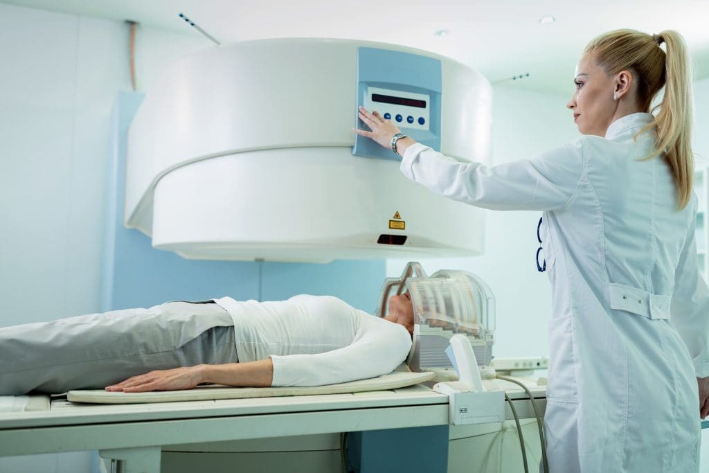 radiologist adjusting mri scanner before medical examination patient who is getting brain scan hospital 1 LIV Hospital